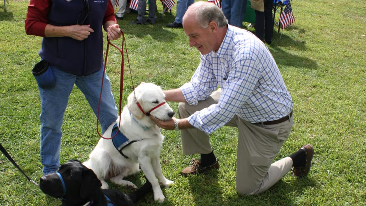 Congressman Keating petting a dog.
