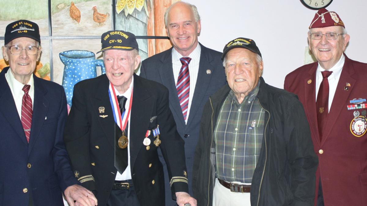 Congressman Keating standing with military veterans.